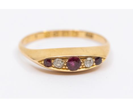 An early 20th century ruby and diamond 18ct gold boat head ring, set with three round mixed cut graduated rubies, with small 