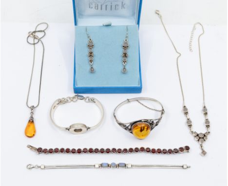 A collection of silver and stone set jewellery to include an amber bangle, comprising an oval amber approx 25mm, within a lea