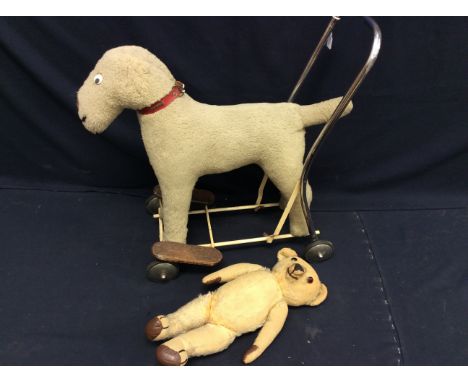 An early 20th century Merrythought teddy bear, along with a child's Tri-Ang style vintage push-a-long dog.&nbsp; (2)