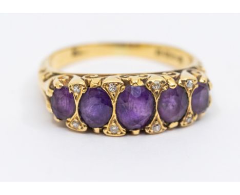 An amethyst and diamond 18ct gold ring, comprising five oval mixed cut graduated amethysts, inset with small diamond accents,