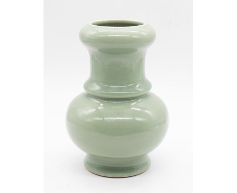 A Chinese celadon glazed porcelain baluster vase, 20th century, with seal mark of the Qianlong Emperor, 17cm high  