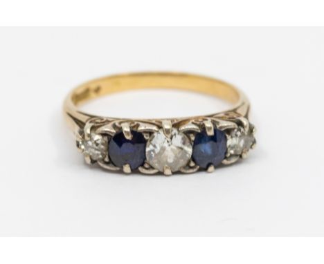 A diamond and sapphire five stone 18ct gold ring, comprising a central old European cut diamond, set either side round mixed 