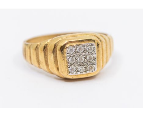 A gents diamond set 9ct gold signet ring, comprising a square top pave set with small round brilliant cut diamonds, ring widt