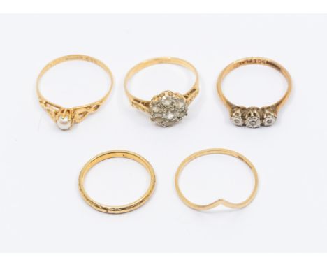 A collection of five 9ct gold rings, to include an illusion set three stone diamond ring, size O1/2, a  topaz set cluster rin