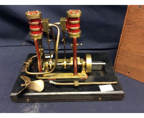 A mid 20th century unmarked horizontal live steam beam engine, in wooden case.
