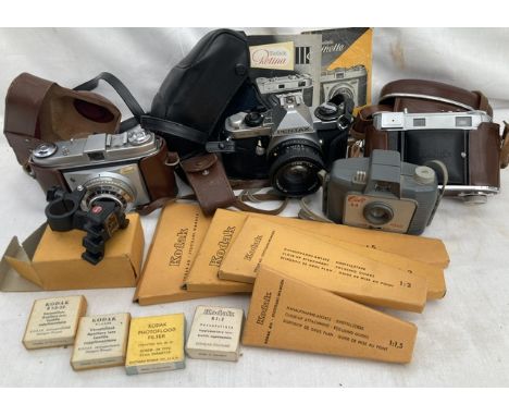 A collection of vintage cameras to include Kodak Retinette, Kodak Retina, Pentax, Colt, along with accessories and filters.. 