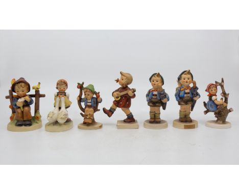 A collection of seven Goebel/Hummel figurines including; Home from Market, Happiness and others.&nbsp;