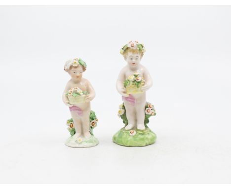 Two late 18th century porcelain putti holding bouquets of flowers, with patch marks to base. Good condition for their age.