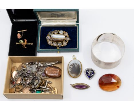 A collection of costume jewellery, comprising a wide engine turned silver cuff bangle, Victorian brooches, including silver b