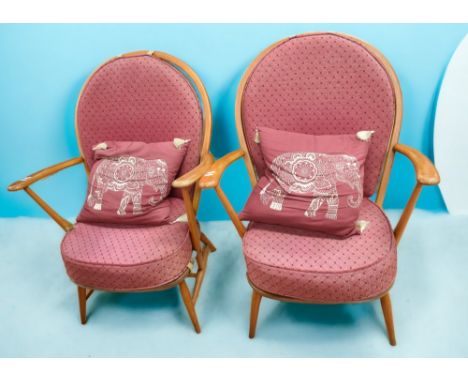 Lucian Ercolani, for Ercol, a pair of Ercol model 317 grandfather chairs, in elm and beech, with cranberry upholstery