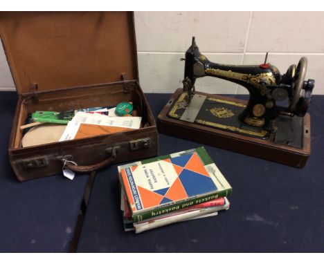 A mixed lot to include a cased Singer sewing machine with instructional handbook, with original oil can and tools in original