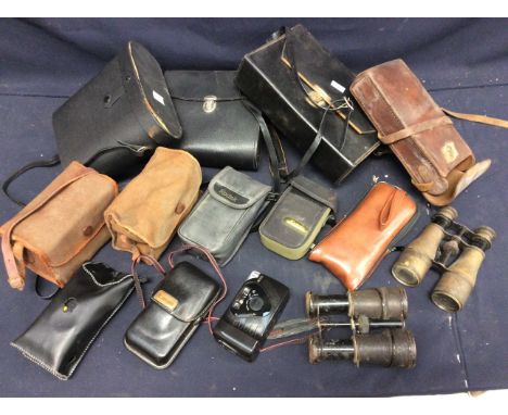 A collection of vintage early to mid 20th century binoculars and cameras including video camera.