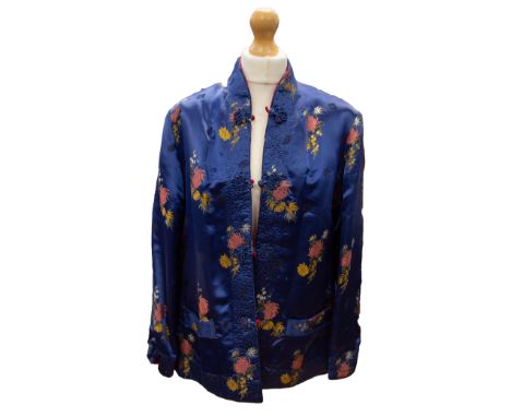 A 1980s deep blue Chinese jacket in an oriental floral design with a reversible red side with embossed floral design: part of