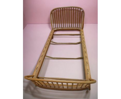 A 20th century Ercol daybed/single bed, curved mattress or seat with spindle head rest and foot rest, missing straps, frame o