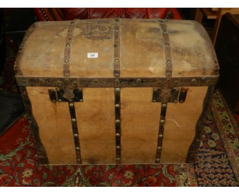 An early 20th century metal bound and canvas dome top travelling trunk.