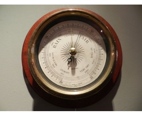 A Metamec aneroid barometer, on a simulated mahogany panel. 