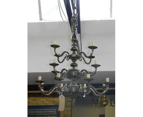 An 18th century Dutch style patinated brass sixteen light electrolier. H: 83cm