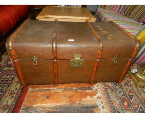 An early 20th century bent wood mounted canvas travelling trunk.