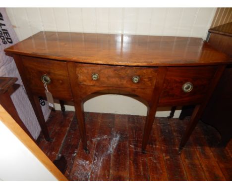 A George III mahogany bow fronted side board, satin wood cross banded, fitted a central drawer flanked by two celarette drawe