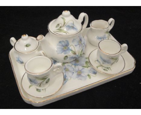 A china Classics tête-à-tête dolls' tea service comprising tray, teapot, milk jug, sr bowl and two tea cups and saucers decor