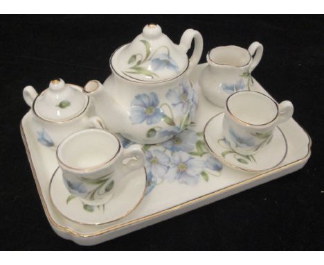 A china Classics tête-à-tête dolls' tea service comprising tray, teapot, milk jug, sr bowl and two tea cups and saucers decor