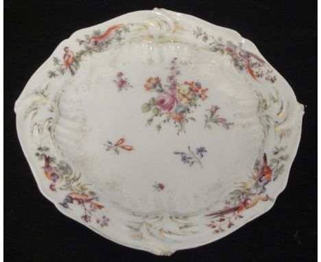 A Chelsea porcelain plate decorated with central floral sprays, the border decorated with exotic birds amongst foliage with g