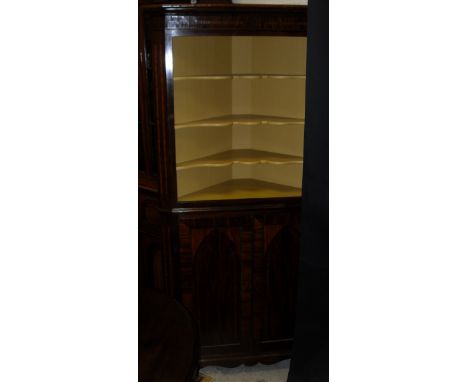 A 19th Century mahogany and inlaid corner cupboard, the upper section with open painted three shelf recess over two arched pa