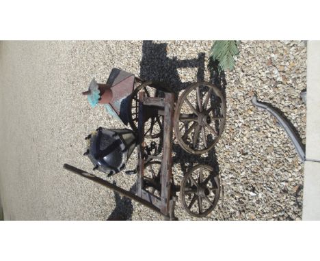 A Victorian cast iron wall mounted light with tapering faceted iron and glass shade, a hand cart and a further outside light 
