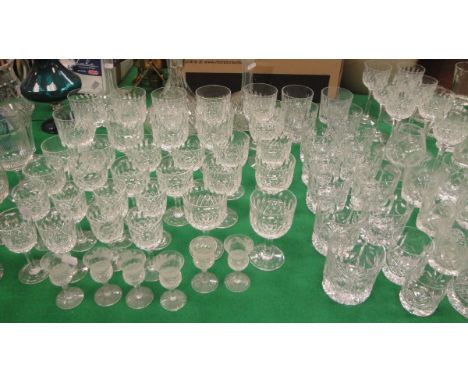 A cut glass decanter with Sheffield silver collar by Reid & Sons Ltd, two further decanters, a set of Thomas Webb wine glasse