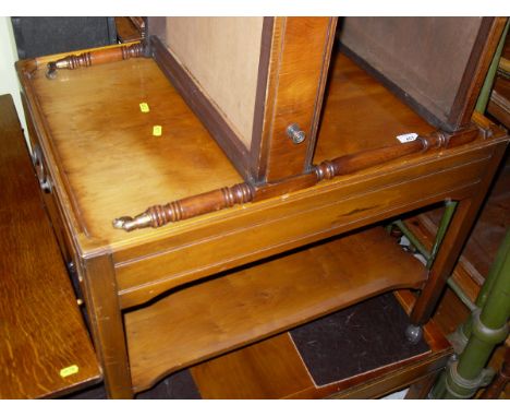 A yew wood two tier tea trolley, a two tier conservatory table, a wood and cross banded centre table with single turned colum