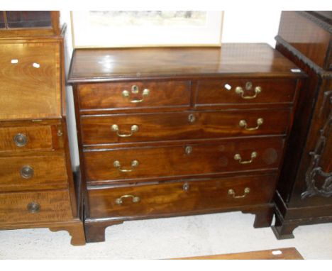 A late George III mahogany chest, the plain top with applied moulded edge over two short and three long graduated drawers wit