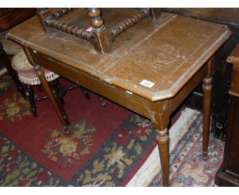 A late Victorian oak writing table, the centre section opening to reveal a transfer decorated inscription "The Britisher Desk