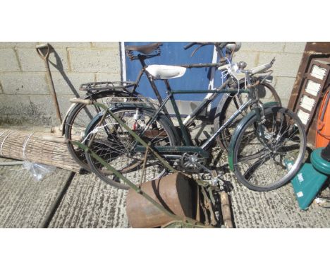 A vintage Triumph gents bicycle, a further vintage gents bicycle and a vintage push mower