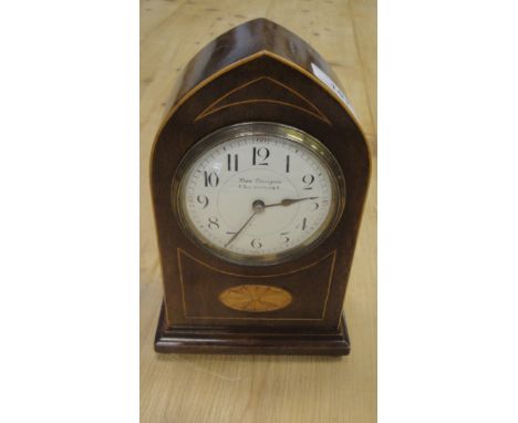 An Edwardian mahogany and inlaid cased mantle clock of lancet form, the movement with circular enamel dial and Arabic numeral