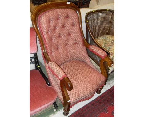 A Victorian mahogany armchair with red and cream ground, diamond pattern button back upholstery with Serpentine front and tur