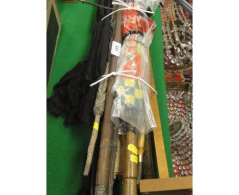 A collection of various walking sticks and parasols including a Victorian bamboo sword stick, a Victorian carved cabbage stal