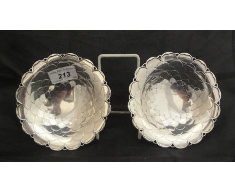 A pair of George V silver pedestal sweet meat dishes with dragon scale and pierced decoration raised on a circular foot (by M