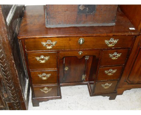 An 18th Century fruitwood kneehole desk, the plain top with moulded edge over a single long drawer and small drawer over a re
