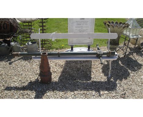 A white painted iron framed and wooden seated and backed garden bench, together with a green painted cast iron Victorian stre
