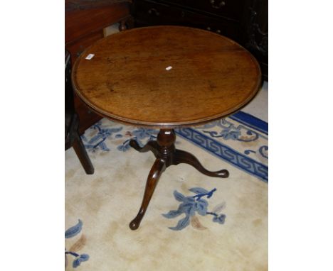 A 19th Century mahogany tea table, the circular dished top with moulded edge on a bird cage to baluster turned pedestal and c