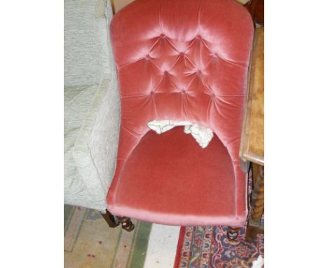 A Victorian pink velvet upholstered button back salon chair on turned front legs to brass caps and castors