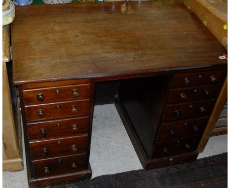 A 19th Century mahogany writing desk with sloped top to pedestals of five graduated drawers, raised on a plinth base   CONDIT