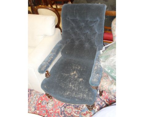 A circa 1900 mahogany framed button back salon chair with blue upholstery, raised on turned and carved front legs to brass ca