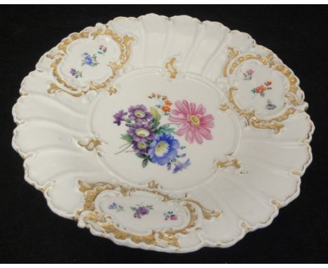 A Meissen plate with central floral spray decorated with cross swords to the base, together with a Vienna porcelain urn of sm