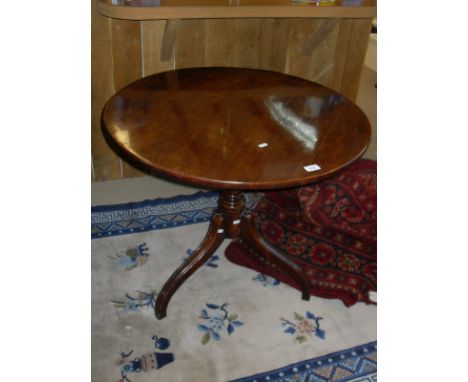 A 19th Century mahogany tilt top occasional table, the circular top above a ringed and turned column support to tripod base