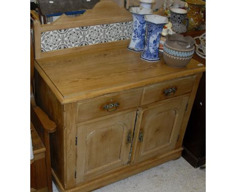 A Victorian Pine North Country tile back side cabinet, the plain top above two drawers and two cupboard doors to plinth base