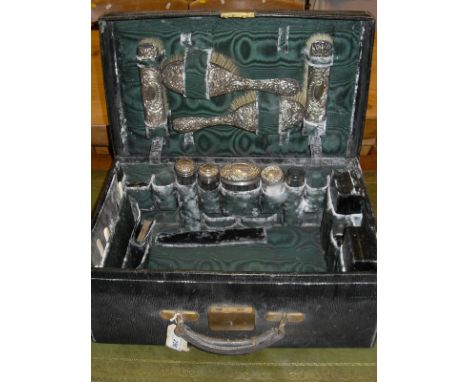 A late Victorian green dyed leather lady's vanity case containing various fittings including manicure items, inkwell, silver 