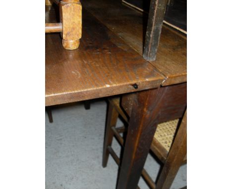 An oak rectangular gate-leg dining table