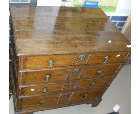 A 19th Century and later Oak chest of four long graduated drawers with brass handles, applied decorative moulding to the draw