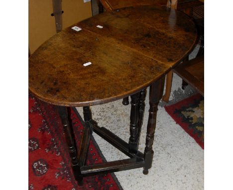 A miniature oak oval single gate-leg drop-leaf occasional table in the 17th Century manner on turned and ringed supports unit